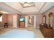 Inviting main bedroom featuring a tray ceiling, soft carpeting, and a doorway to the hall at 608 Ridge Crossing Dr, Woodstock, GA 30189