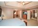 Serene main bedroom with a tray ceiling, plush carpeting, and a doorway leading to the bathroom at 608 Ridge Crossing Dr, Woodstock, GA 30189