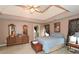 Bright main bedroom featuring a tray ceiling, neutral colors, and en-suite bathroom at 608 Ridge Crossing Dr, Woodstock, GA 30189