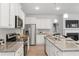 Kitchen with stainless steel appliances, granite counters and view of living space at 7021 Old Bridge Ln, Conyers, GA 30013