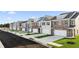 Street view of new construction townhomes with attached garages and manicured lawns at 7021 Old Bridge Ln, Conyers, GA 30013