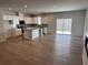 Open concept kitchen and living area with hardwood floors and sliding glass doors to the backyard at 986 Southland Ln (Lot 32), Lawrenceville, GA 30043