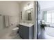 Charming bathroom with white tile floors, gray vanity with granite countertop, and modern lighting at 1074 Fairway Ne Ests, Atlanta, GA 30319