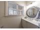 Elegant bathroom with a decorative mirror, white marble countertop, and bright natural light at 1074 Fairway Ne Ests, Atlanta, GA 30319