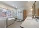 Stylish bathroom showcasing a freestanding tub, a glass shower, and a double vanity with marble counters at 1074 Fairway Ne Ests, Atlanta, GA 30319