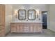 Lovely bathroom featuring double sinks with elegant mirrors, custom cabinets, and modern fixtures at 1074 Fairway Ne Ests, Atlanta, GA 30319