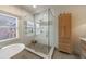 Beautiful bathroom featuring a glass shower with stone floor, soaker tub, and built-in storage at 1074 Fairway Ne Ests, Atlanta, GA 30319