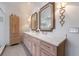 Bathroom featuring double vanity with marble countertop, custom cabinets, and decorative lighting fixtures at 1074 Fairway Ne Ests, Atlanta, GA 30319