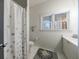 Well-lit bathroom with a decorative shower curtain, white tile, and gray accents at 1074 Fairway Ne Ests, Atlanta, GA 30319