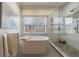 A luxurious bathroom featuring a standalone tub, seamless glass shower, and a serene, spa-like ambiance at 1074 Fairway Ne Ests, Atlanta, GA 30319