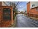 A gated entrance to Fairway Estates with secure black iron gates and brick pillars for added privacy at 1074 Fairway Ne Ests, Atlanta, GA 30319