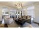 Bright living room featuring a gray sofa, decorative lighting, and an open view to the kitchen at 1074 Fairway Ne Ests, Atlanta, GA 30319