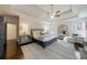 Sun-filled main bedroom boasts a tray ceiling, fireplace, hardwood floors, and calming neutral palette at 1074 Fairway Ne Ests, Atlanta, GA 30319