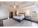 Spacious and sunny main bedroom featuring a tray ceiling, dark hardwood floors, and neutral decor at 1074 Fairway Ne Ests, Atlanta, GA 30319