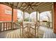 Covered patio featuring a ceiling fan, white table and chairs, and a view of the city at 1074 Fairway Ne Ests, Atlanta, GA 30319