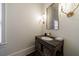 Stylish powder room featuring a unique vanity with a stone countertop and decorative mirror at 1074 Fairway Ne Ests, Atlanta, GA 30319