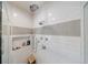 Close up of the tiled shower with a stone floor, rainfall shower head, and built-in niche at 1074 Fairway Ne Ests, Atlanta, GA 30319