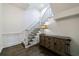 Elegant staircase with hardwood floors, lamp on a table, and dark metal railings at 1074 Fairway Ne Ests, Atlanta, GA 30319