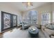 Inviting sunroom featuring a ceiling fan, arched window, and cozy seating arrangement at 1074 Fairway Ne Ests, Atlanta, GA 30319