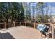 Backyard deck with railing and bench seating overlooking the landscaped yard at 112 Rocky Creek Trl, Woodstock, GA 30188