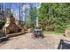 Backyard patio featuring a stone fireplace and outdoor dining area, perfect for entertaining at 112 Rocky Creek Trl, Woodstock, GA 30188