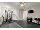 Spacious finished basement with gym equipment, a ceiling fan and an entertainment center at 112 Rocky Creek Trl, Woodstock, GA 30188