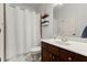 Well-lit bathroom featuring a vanity with modern fixtures and a shower with a white curtain at 112 Rocky Creek Trl, Woodstock, GA 30188