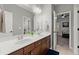 Bathroom with double sinks and a large mirror over dark cabinets at 112 Rocky Creek Trl, Woodstock, GA 30188