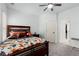 Bedroom with wooden bed frame, ceiling fan, and neutral carpeting at 112 Rocky Creek Trl, Woodstock, GA 30188