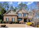 Charming, two-story brick home with well-manicured landscaping and a welcoming front yard at 112 Rocky Creek Trl, Woodstock, GA 30188