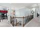 Second floor hallway with decorative wrought iron spindles and natural light at 112 Rocky Creek Trl, Woodstock, GA 30188