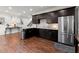 Modern kitchenette with stainless steel appliances, dark cabinets, and granite countertops at 112 Rocky Creek Trl, Woodstock, GA 30188