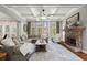 Inviting living room with stone fireplace, coffered ceiling, large windows, and hardwood floors at 112 Rocky Creek Trl, Woodstock, GA 30188