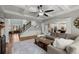 Bright living room with coffered ceilings, fireplace, and open floor plan leading to kitchen and stairway at 112 Rocky Creek Trl, Woodstock, GA 30188