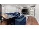 Cozy living room with a built-in fireplace and shelving, a large blue sofa, and hardwood floors at 112 Rocky Creek Trl, Woodstock, GA 30188