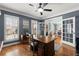 Functional home office with a wooden desk, plenty of natural light, and French doors at 112 Rocky Creek Trl, Woodstock, GA 30188