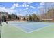 Well-maintained community tennis courts with lighting and surrounding landscaping for an active lifestyle at 112 Rocky Creek Trl, Woodstock, GA 30188