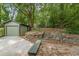 Private backyard with a detached garage and a stone retaining wall at 1748 Alvarado Sw Ter, Atlanta, GA 30310