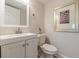 Bathroom includes a white vanity, toilet, mirror, and towel holder at 1748 Alvarado Sw Ter, Atlanta, GA 30310