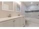 Bathroom featuring a double vanity and marble-tiled shower at 1748 Alvarado Sw Ter, Atlanta, GA 30310