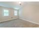 Cozy bedroom featuring neutral walls, plush carpeting, and natural light from two windows at 1748 Alvarado Sw Ter, Atlanta, GA 30310