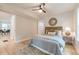 Bedroom featuring hardwood floors, ceiling fan, and access to the ensuite bathroom and living room at 1748 Alvarado Sw Ter, Atlanta, GA 30310