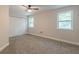 Bedroom featuring neutral paint, carpeted floor, ceiling fan, closet, and bright natural light from two windows at 1748 Alvarado Sw Ter, Atlanta, GA 30310