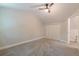 Carpeted bedroom with ceiling fan, and a closet offering ample space for storage solutions at 1748 Alvarado Sw Ter, Atlanta, GA 30310