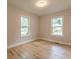 Bedroom features hardwood floors, two windows, and a neutral color scheme at 1748 Alvarado Sw Ter, Atlanta, GA 30310