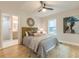 Bedroom featuring ceiling fan, a decorative mirror, and access to ensuite bathroom at 1748 Alvarado Sw Ter, Atlanta, GA 30310