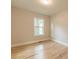 Bedroom showcasing hardwood floors, light-colored walls, and a window at 1748 Alvarado Sw Ter, Atlanta, GA 30310