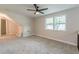 Bonus room with neutral paint, carpeted floor, ceiling fan, and bright natural light from two windows at 1748 Alvarado Sw Ter, Atlanta, GA 30310