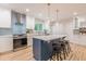 A modern kitchen features a large central island with seating, stainless appliances, and pendant lighting at 1748 Alvarado Sw Ter, Atlanta, GA 30310