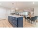 Kitchen island with a white countertop, storage cabinets, and modern pendant lighting, with an open floor plan at 1748 Alvarado Sw Ter, Atlanta, GA 30310